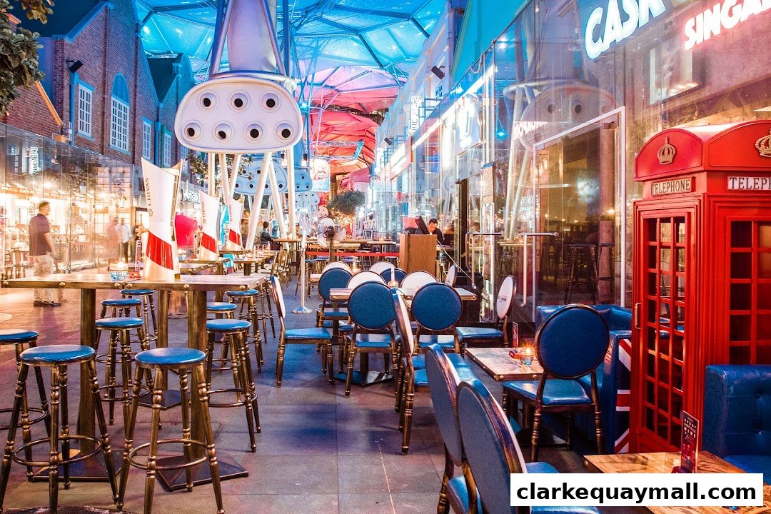 An outdoor seating area of a bistro with blue chairs, tables, and a red telephone booth.