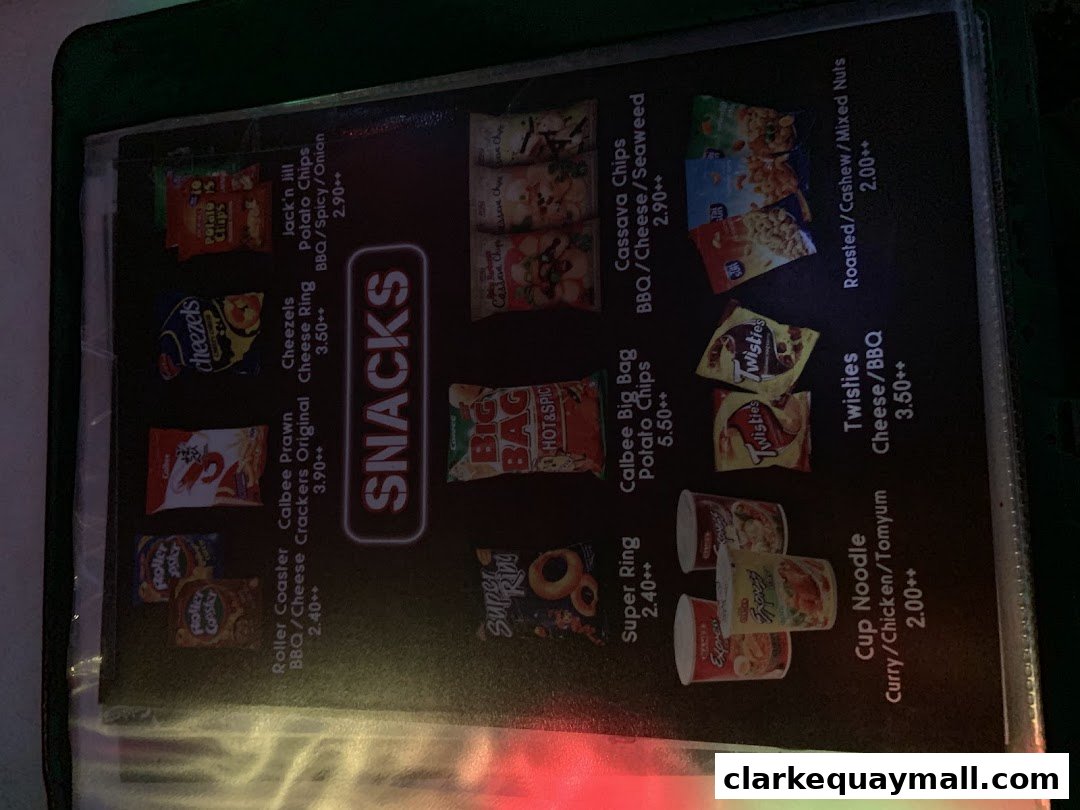 A menu displaying various snack items with prices, including chips, crackers, and cup noodles.