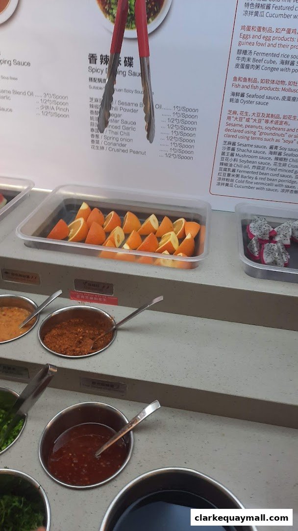 A selection of fresh fruit and condiments for hot pot dining.