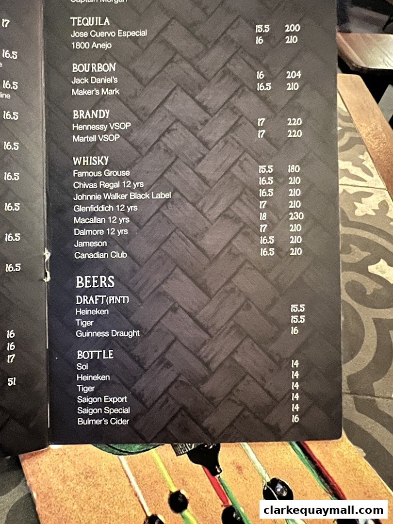 A menu featuring a selection of tequilas, bourbons, brandies, whiskies, and beers with prices.