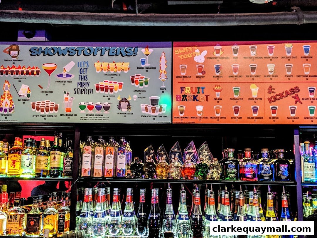A bar menu featuring various shot concoctions and drinks with colorful illustrations and prices.