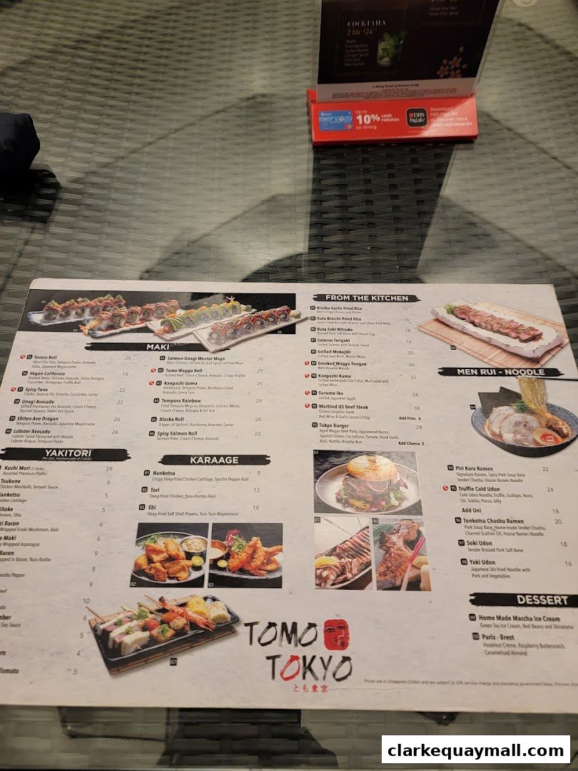 A menu from Tomo Tokyo featuring sushi, yakitori, noodles, and desserts.