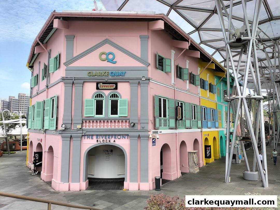 A colorful building at Clarke Quay, featuring the 'Level Up' sign and arched entrances.