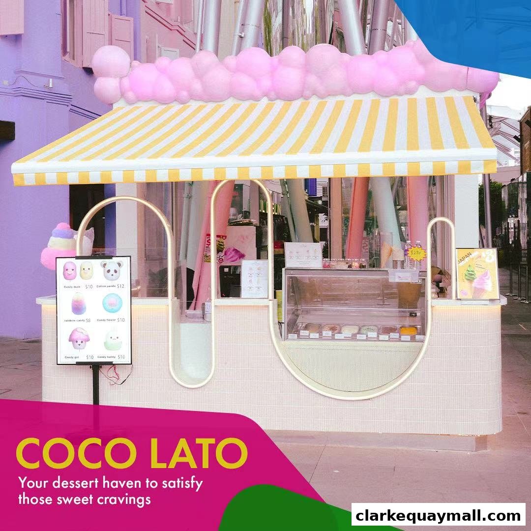 A charming dessert kiosk with a yellow and white striped awning, displaying colorful candies and ice cream.