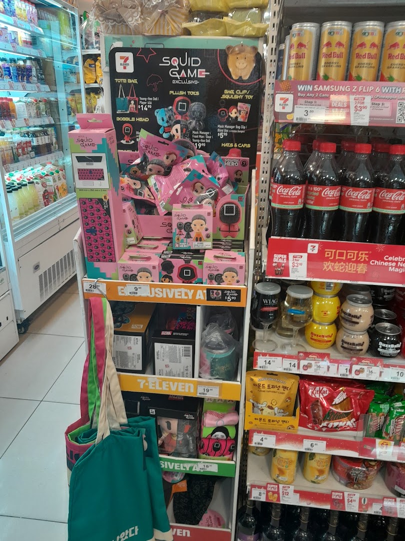 An in-store display at 7-Eleven featuring exclusive Squid Game merchandise alongside beverages and snacks.