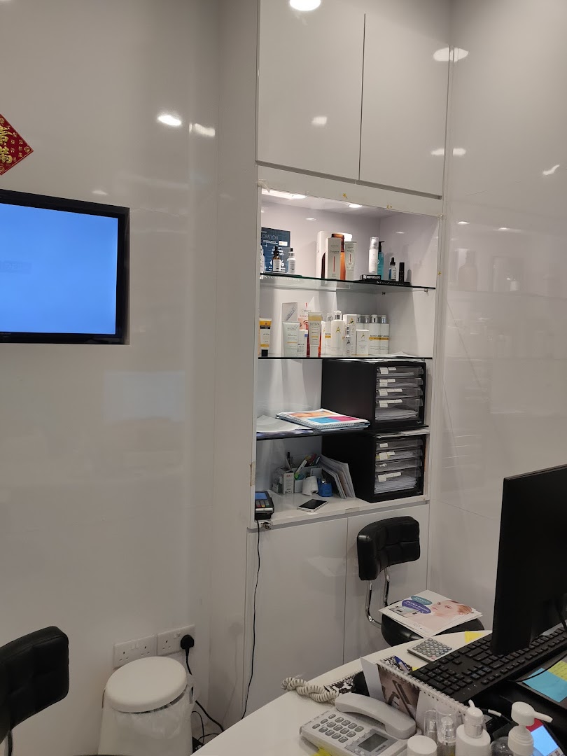 Interior view of A.M Aesthetics Clementi, showing a clean reception area with product displays and a desk.