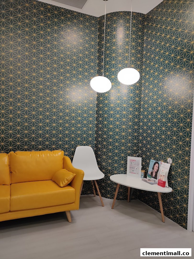 A vibrant waiting area with a yellow sofa, patterned wallpaper, and a small table with brochures.