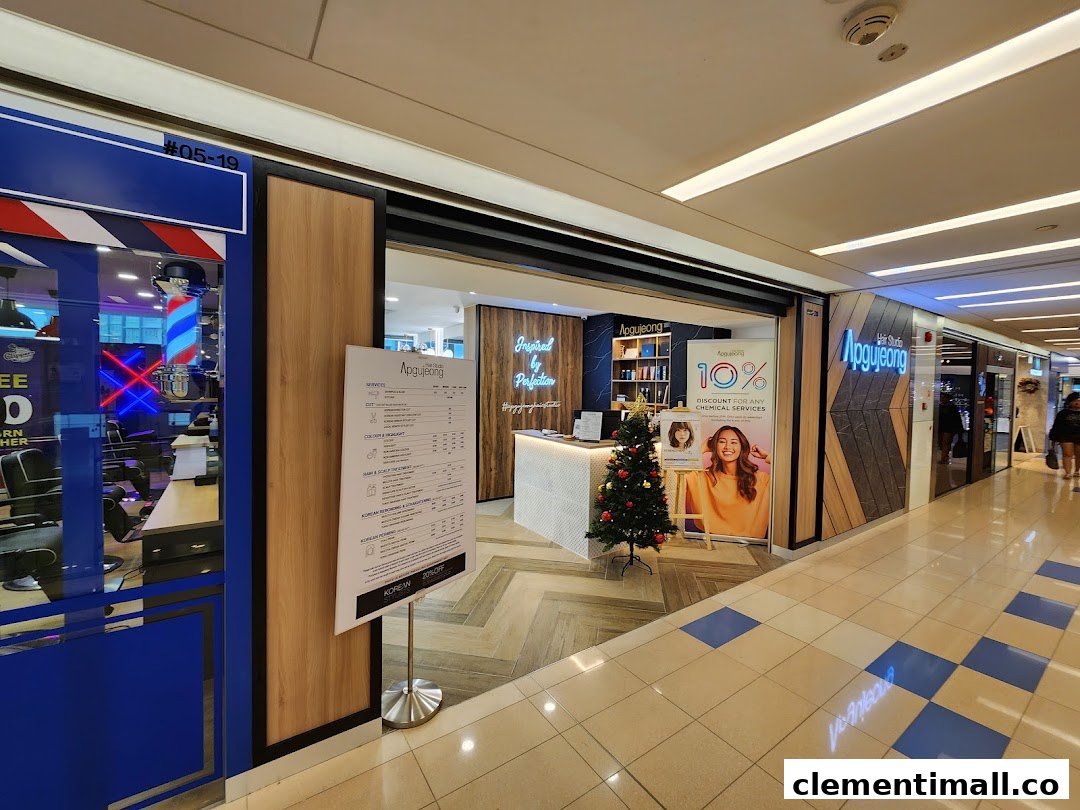 The shopfront of Apgujeong Hair Studio featuring a detailed services and price list, with festive decorations.
