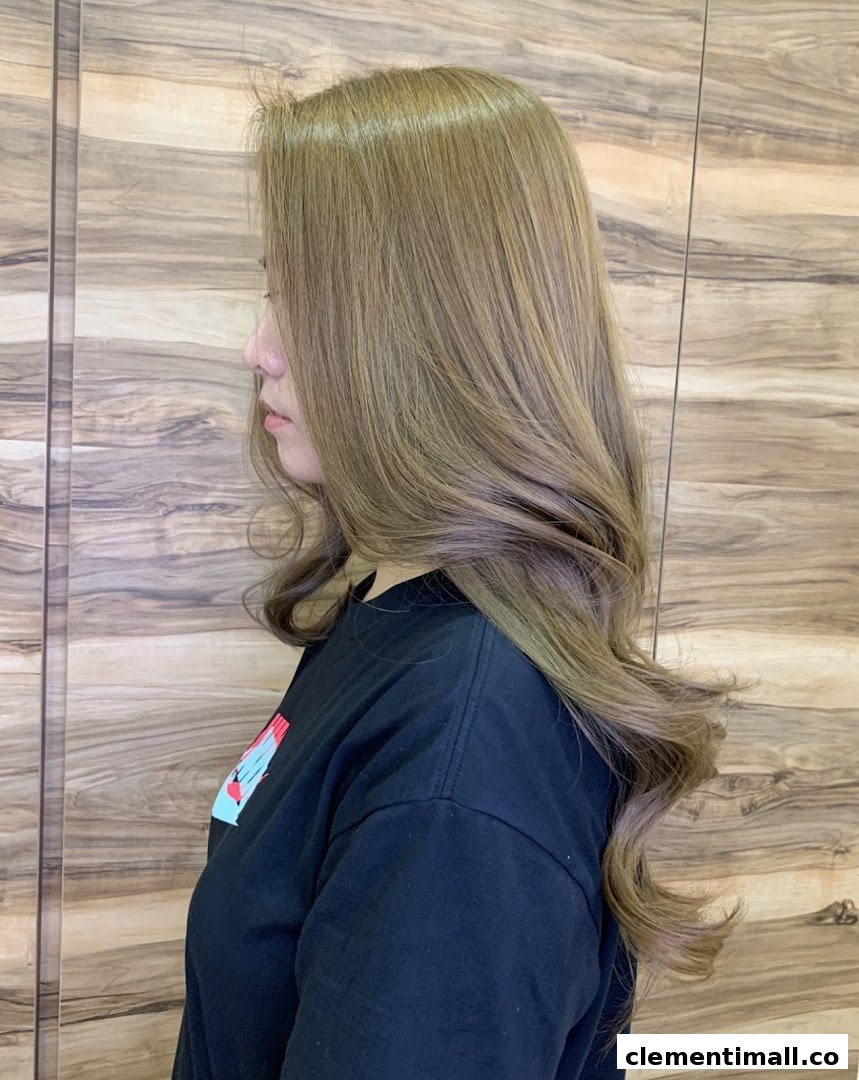 A side profile of a person showcasing beautifully styled, light brown hair with soft waves.