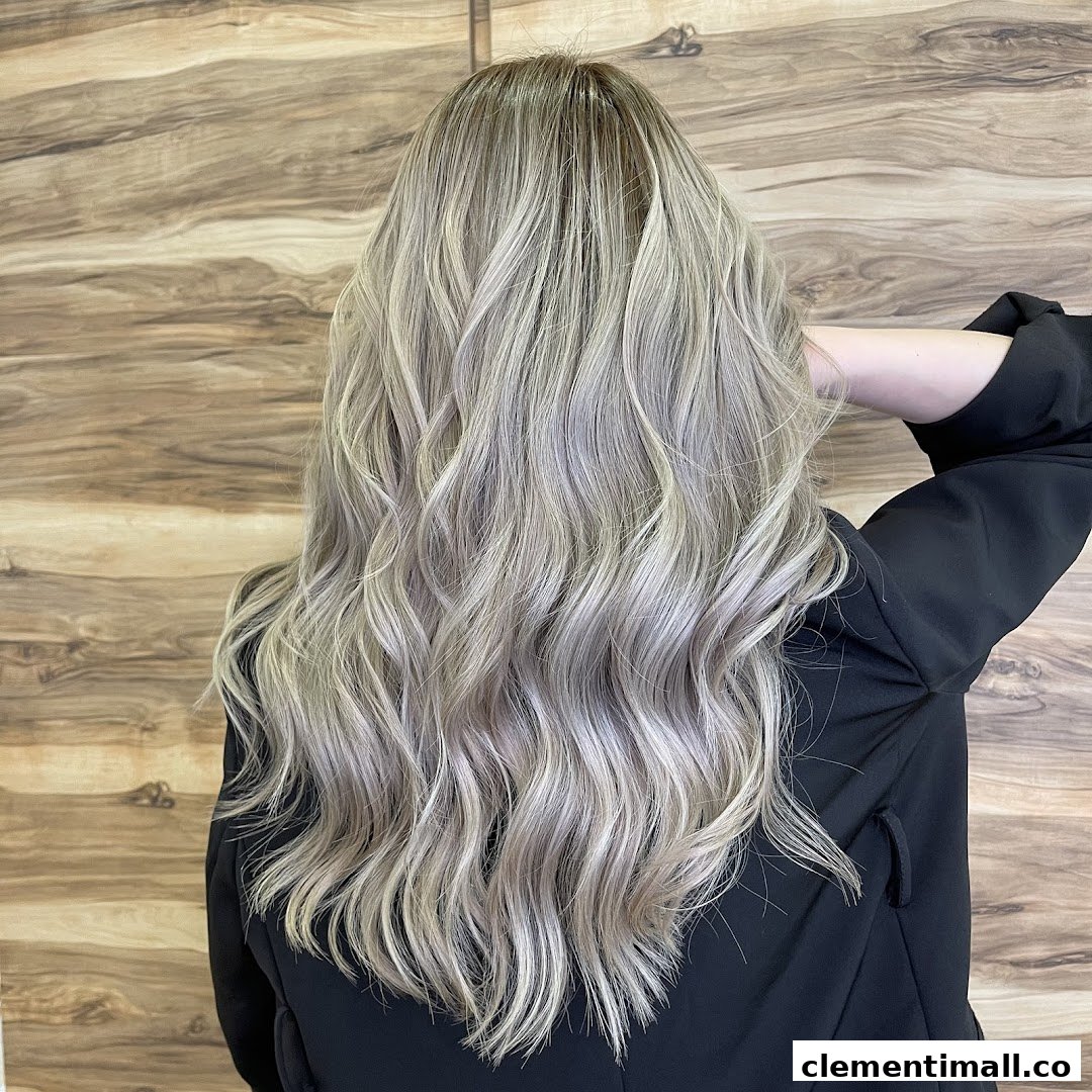 A person from behind showcasing long, wavy, ash blonde hair with highlights.