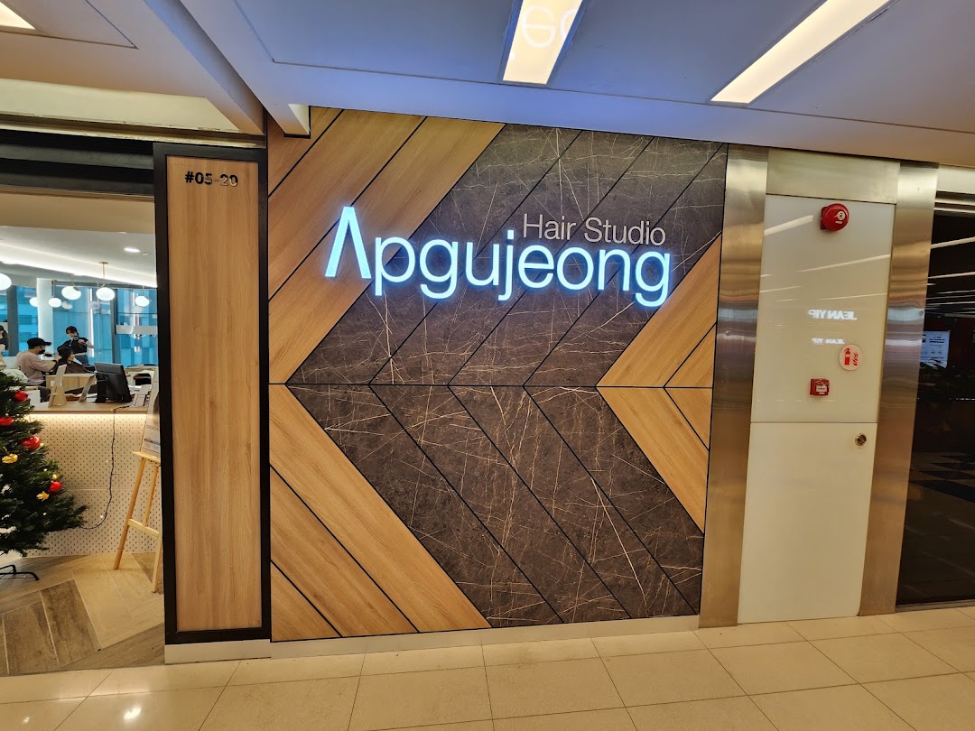 The illuminated exterior sign and inviting entrance of Apgujeong Hair Studio at The Clementi Mall.