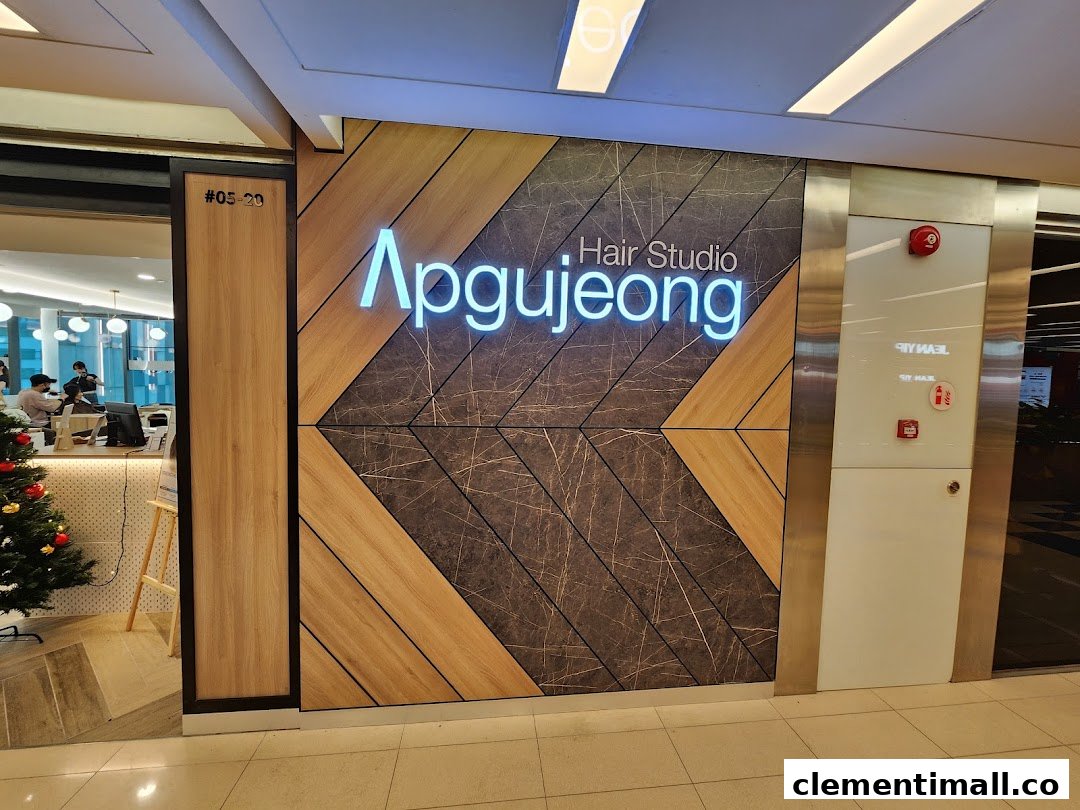 The illuminated exterior sign and inviting entrance of Apgujeong Hair Studio at The Clementi Mall.