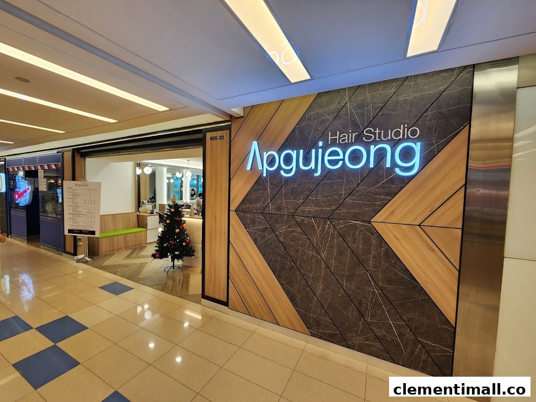The modern entrance of Apgujeong Hair Studio featuring a festive Christmas tree inside.