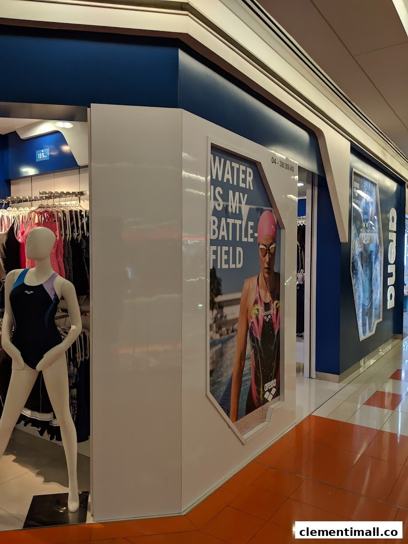 The vibrant blue and white shopfront of Arena, showcasing swimwear on mannequins and a 'Water is my Battlefield' poster.