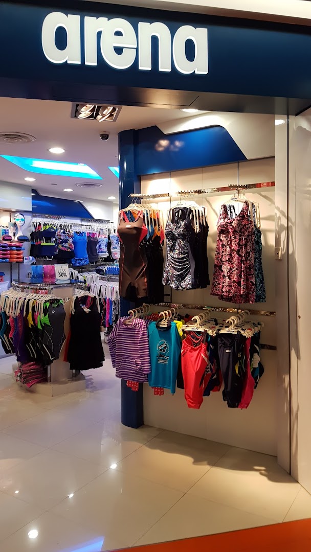 The entrance of Arena swimwear shop, showcasing a variety of swimsuits and aquatic apparel.