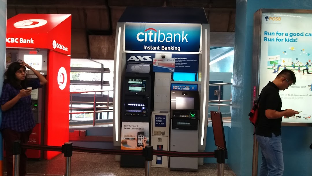 People using Citibank, OCBC Bank, and AXS self-service banking kiosks at a mall.