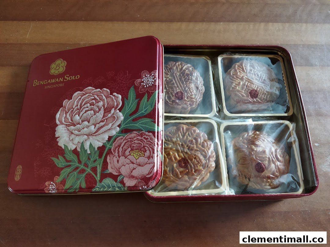 A decorative red tin box from Bengawan Solo containing four individually wrapped mooncakes.