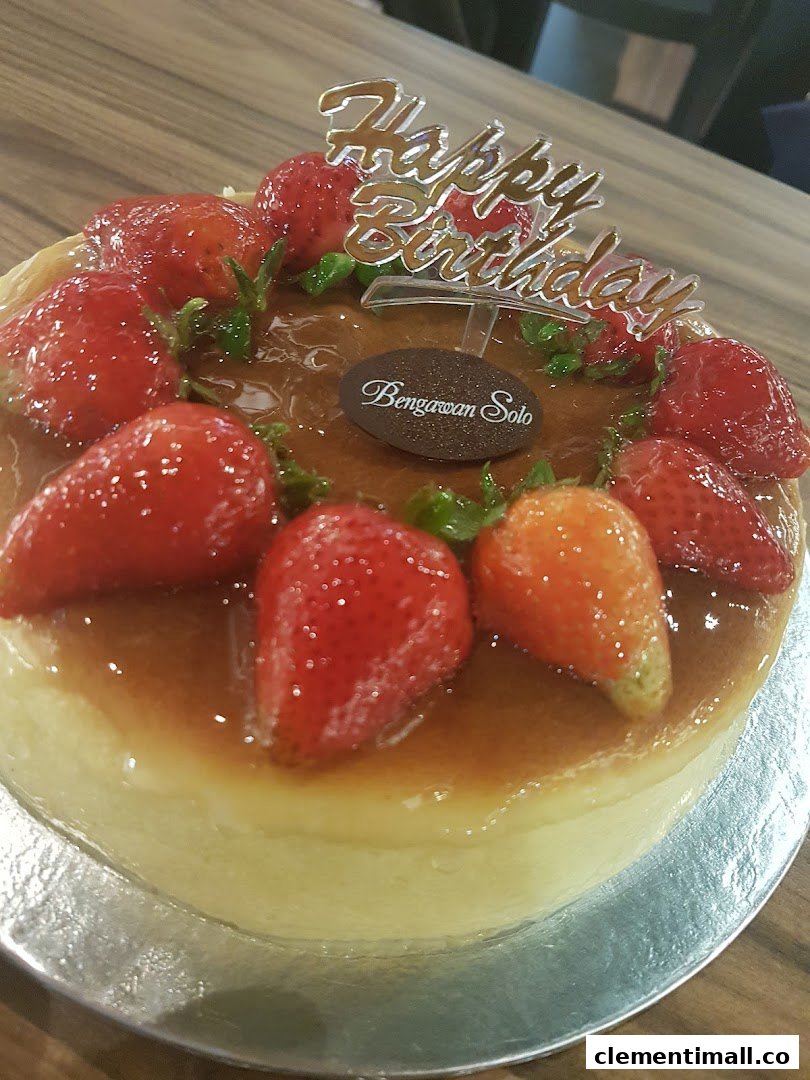 A delicious strawberry-topped cake with a 'Happy Birthday' topper from Bengawan Solo.