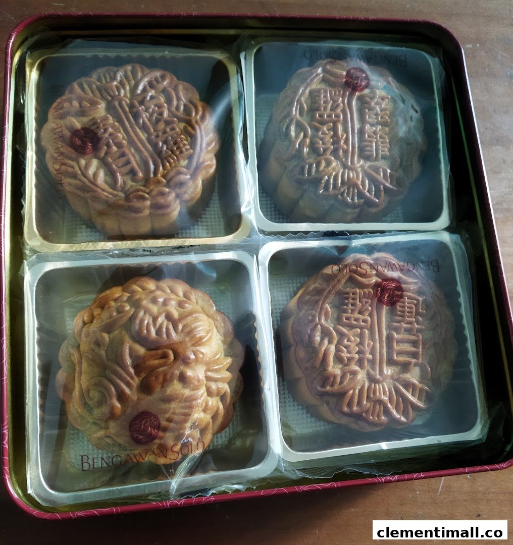 A tin box containing four intricately designed mooncakes, individually wrapped, from Bengawan Solo.