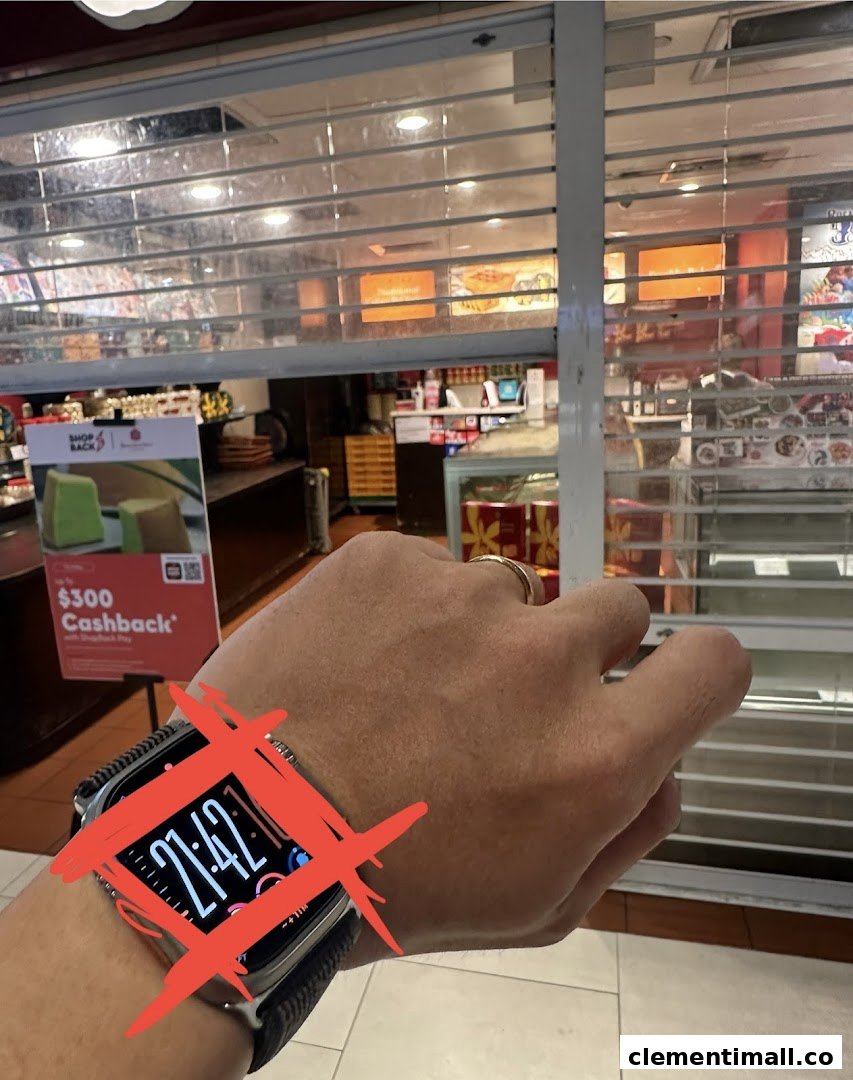 View of Bengawan Solo shop interior through a partially closed security shutter, showing products and a promotional sign.