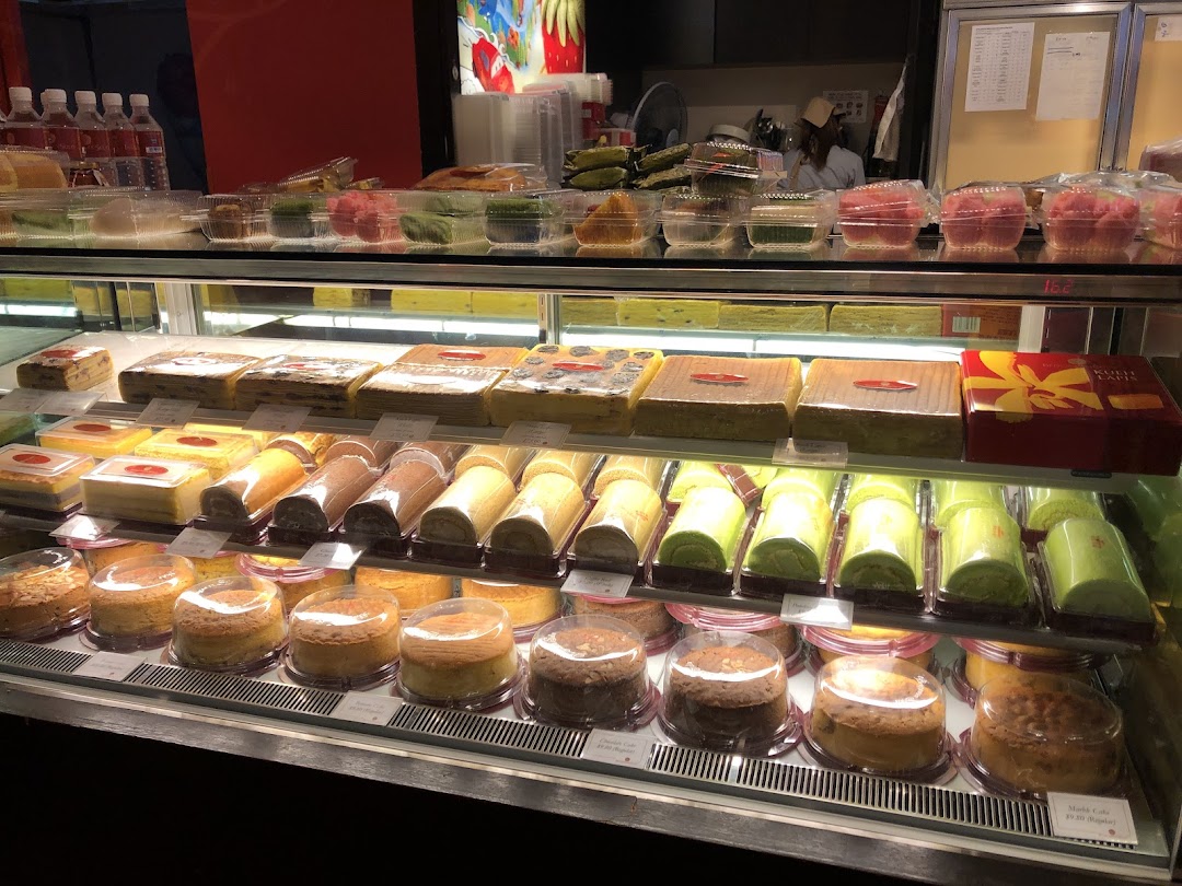 A vibrant display case filled with a variety of traditional Indonesian cakes and pastries at Bengawan Solo.
