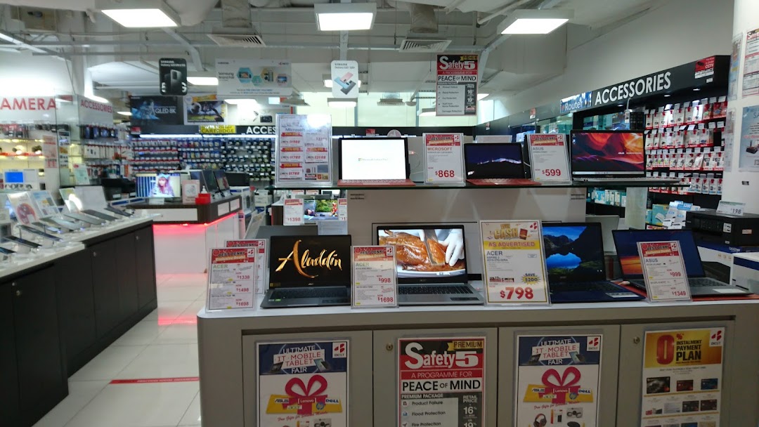 Interior of Best Denki showcasing a wide array of laptops, tablets, and electronic accessories.