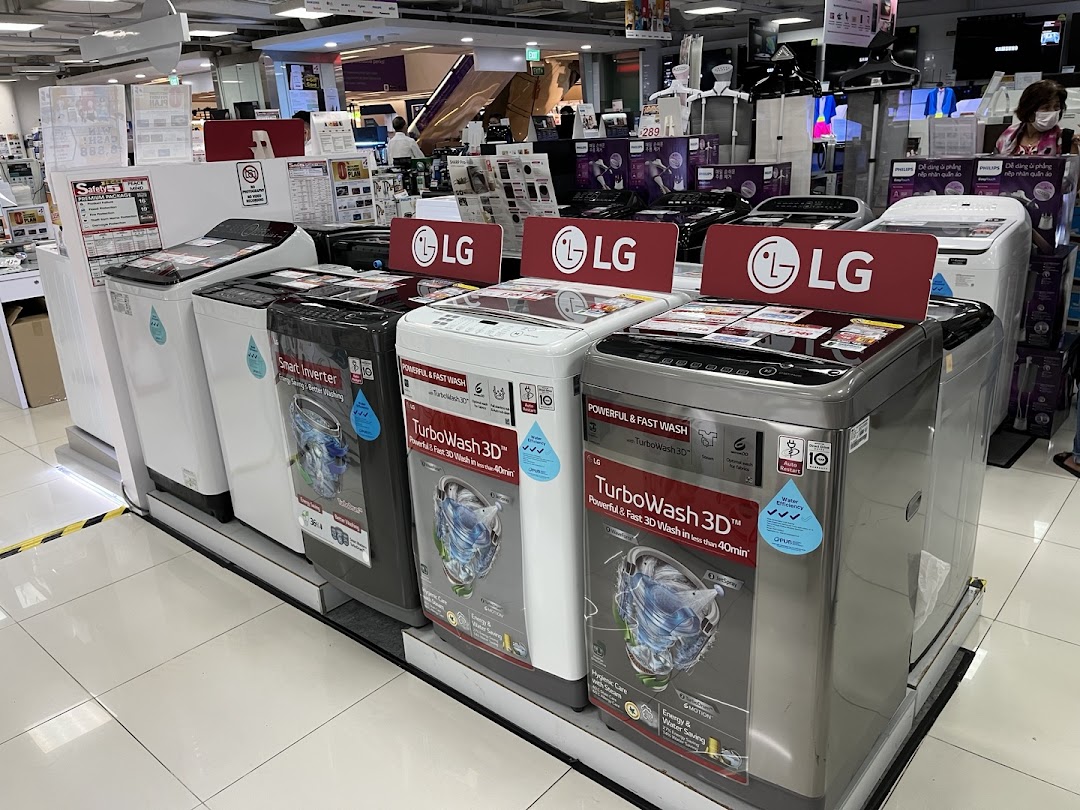 A display of LG washing machines inside Best Denki, showcasing various models and features.