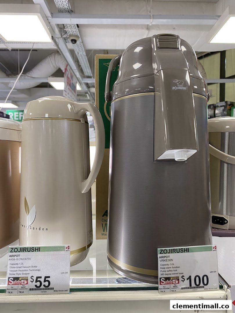 Two Zojirushi airpots displayed with their features and prices on a shelf in an electronics store.