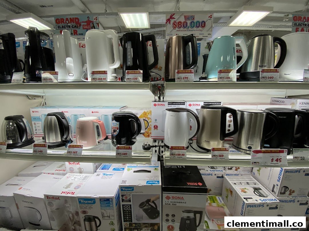 A display shelf at Best Denki showcasing a wide variety of electric kettles in different colors and brands.