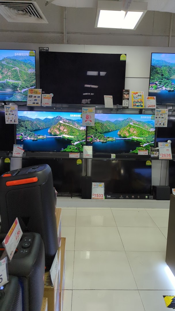 A display of various Samsung televisions and audio equipment inside an electronics store.