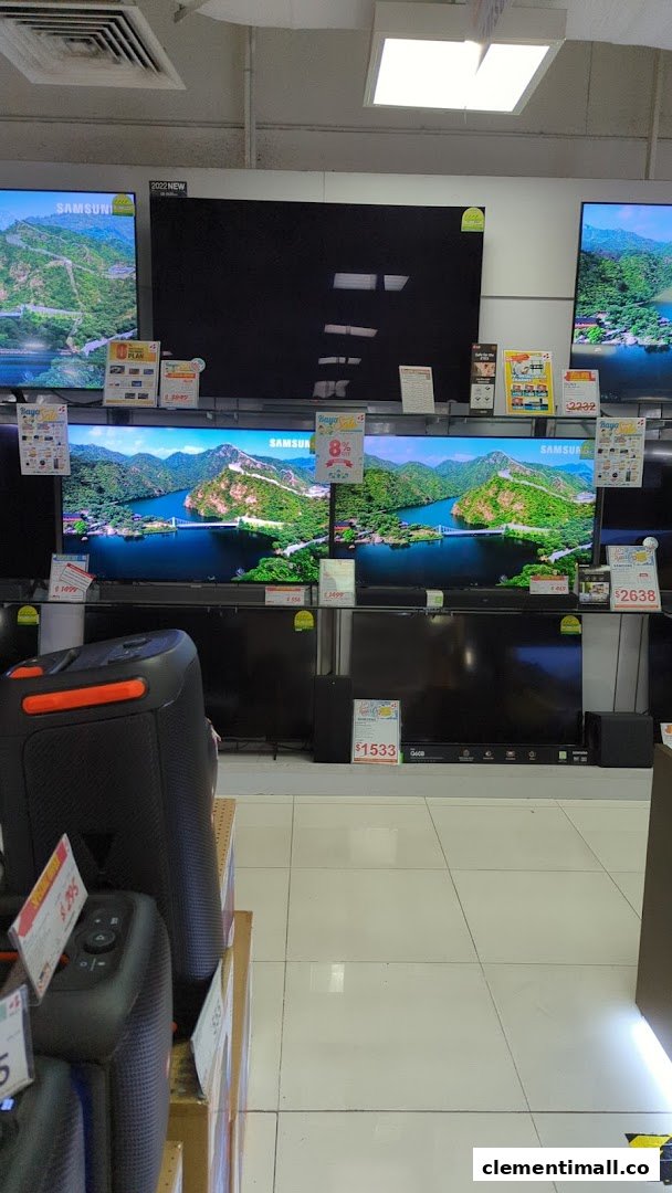A display of various Samsung televisions and audio equipment inside an electronics store.
