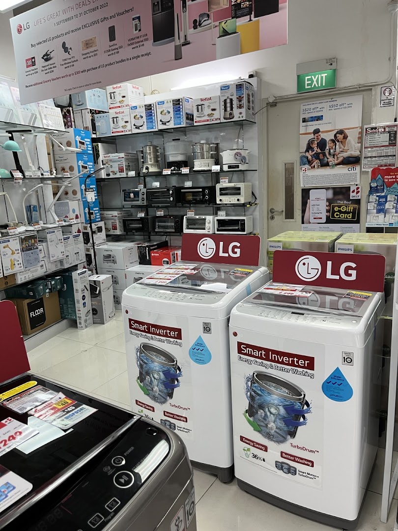 An interior shot of Best Denki, showcasing LG washing machines, small kitchen appliances, and promotional displays.
