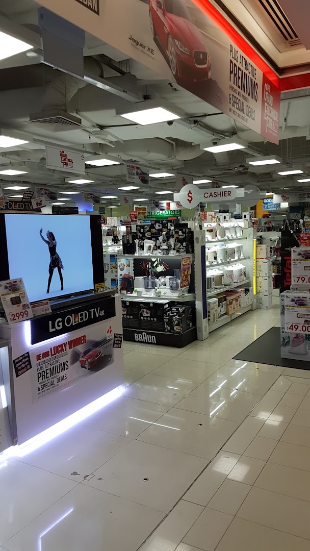 An interior view of Best Denki, showcasing a large LG OLED TV display, various home appliances, and promotional signage.