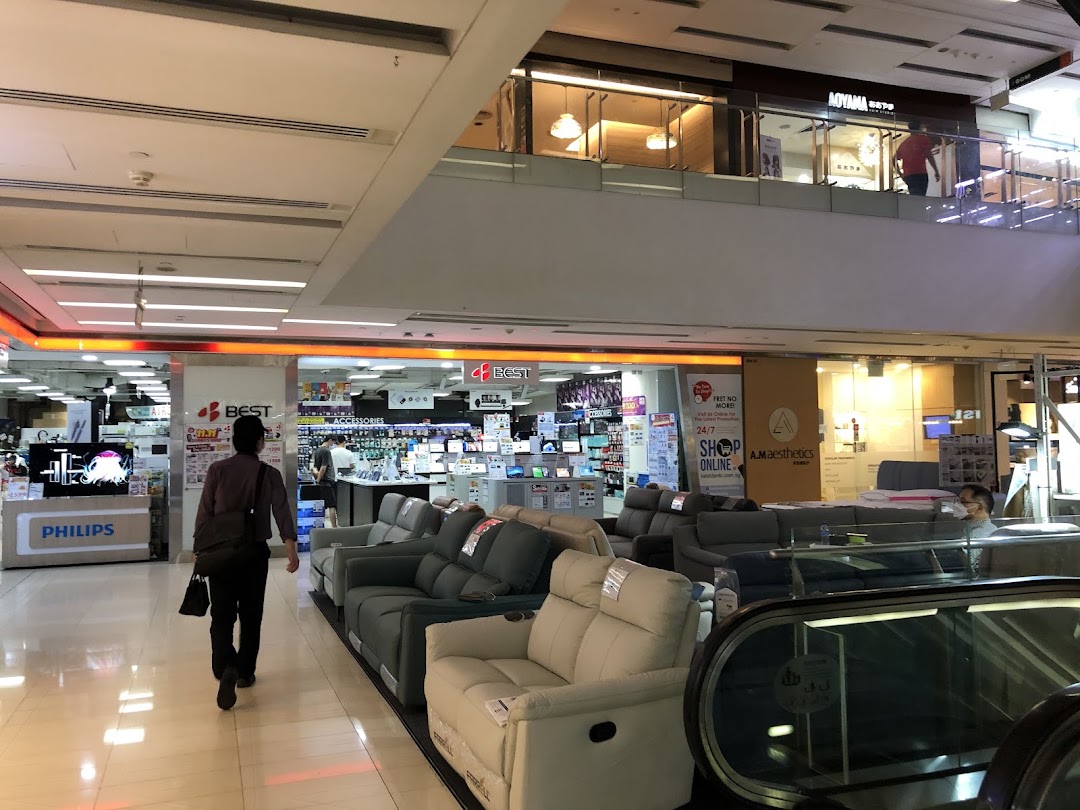 Interior view of Best Denki electronics store entrance within a bustling shopping mall.