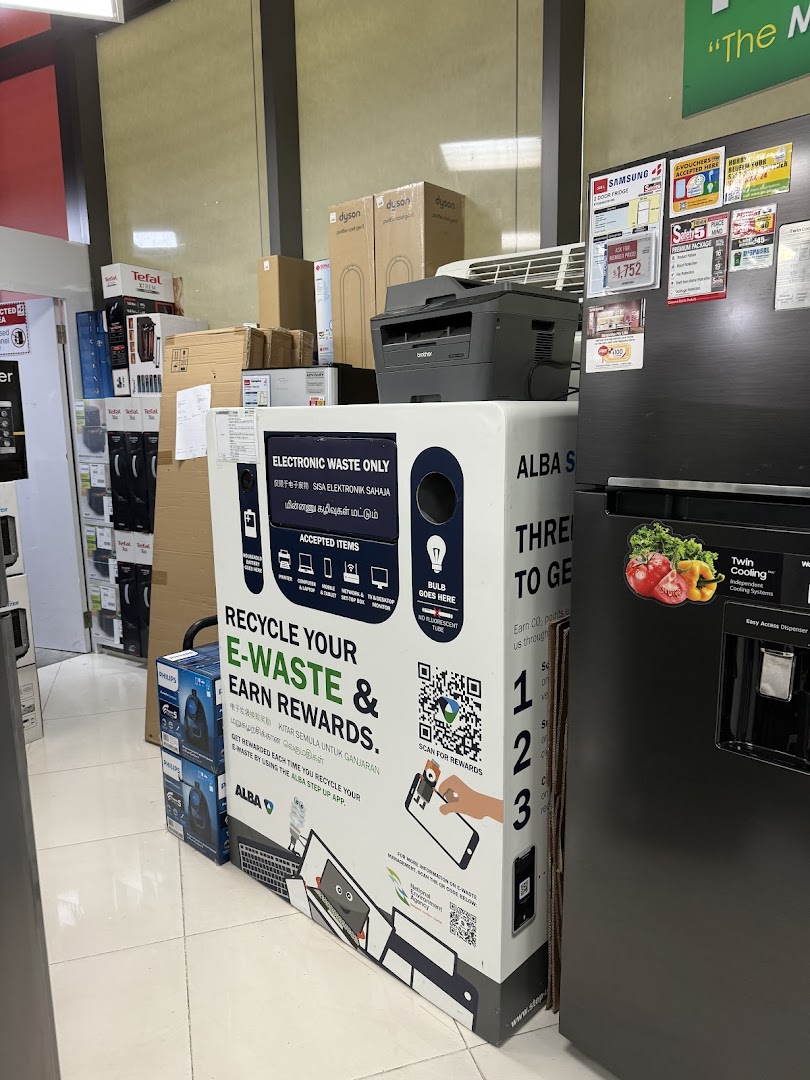 An e-waste recycling bin and various electronics, including a refrigerator, inside Best Denki.