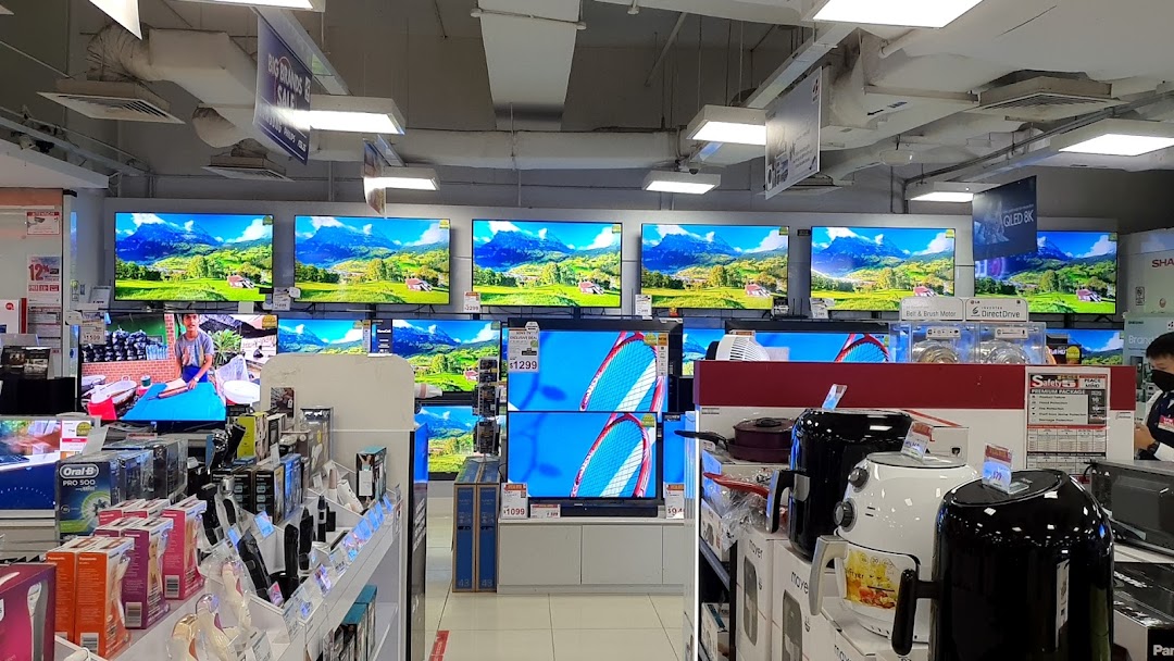 An interior view of Best Denki, showcasing rows of televisions, small appliances, and various electronics.
