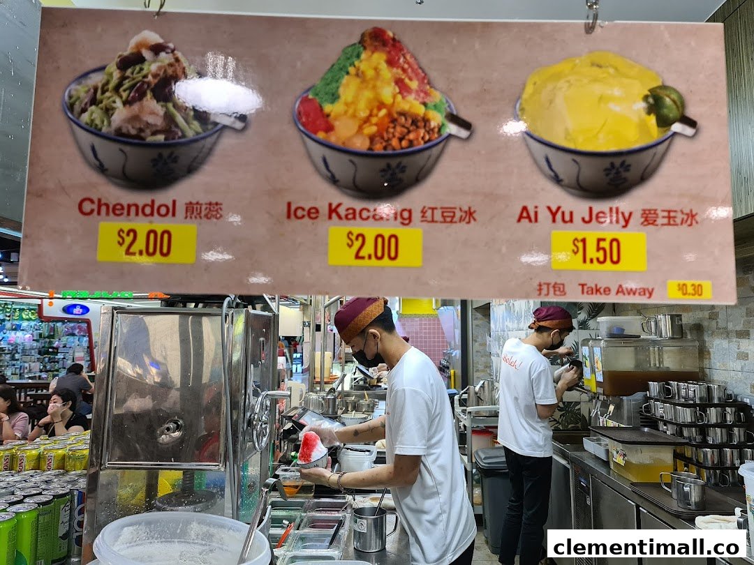 A menu board displaying Chendol, Ice Kacang, and Ai Yu Jelly prices, with staff preparing desserts.