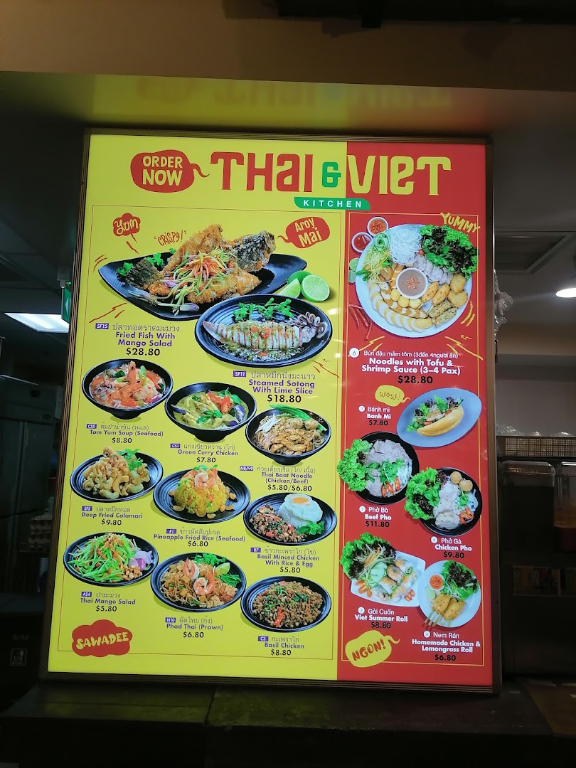 A brightly lit menu board displaying a variety of Thai and Vietnamese dishes with prices.