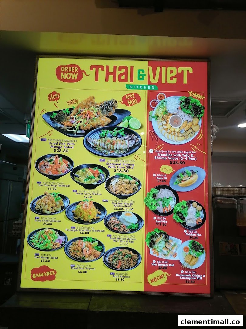 A brightly lit menu board displaying a variety of Thai and Vietnamese dishes with prices.