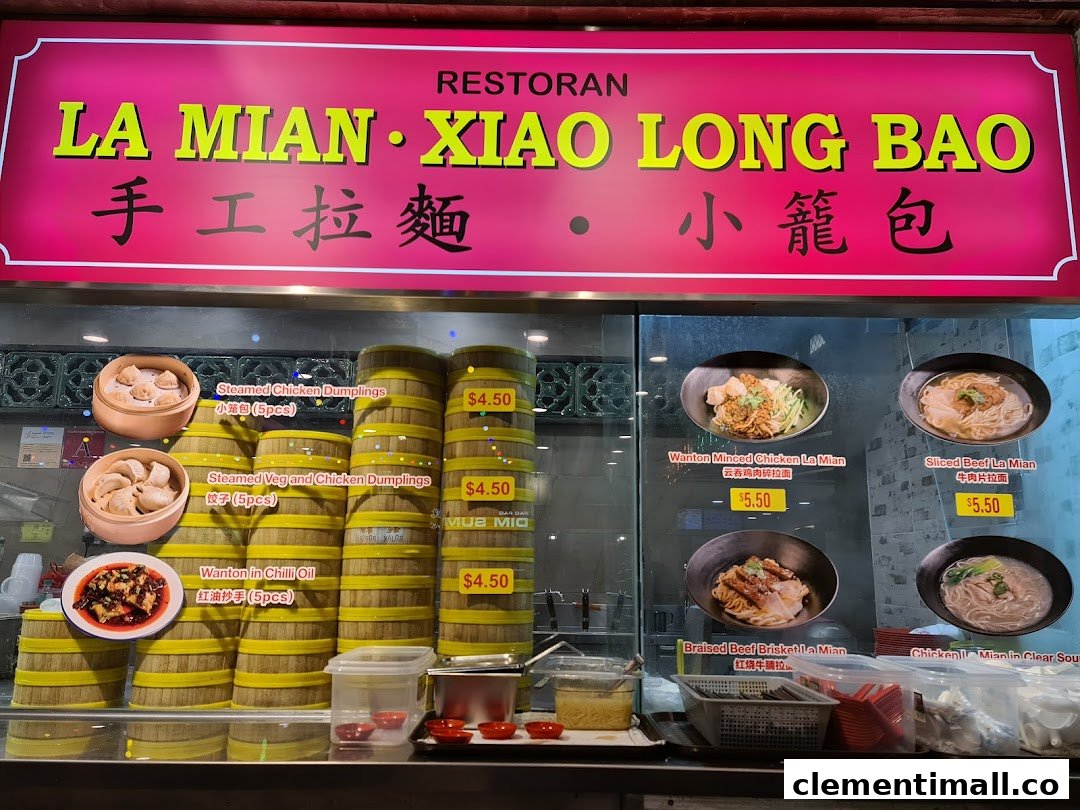 A vibrant display of authentic Chinese dumplings and La Mian noodles with prices at a food stall counter.