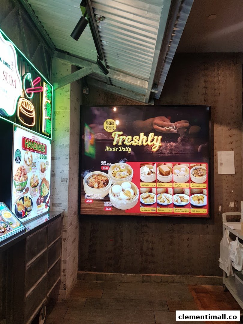 A digital menu board displaying various freshly made dim sum items with prices inside a shop.