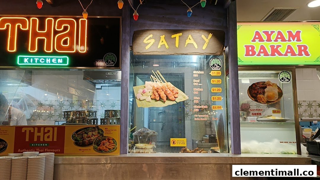 A vibrant food stall offering Thai cuisine, satay skewers, and Ayam Bakar with visible prices.