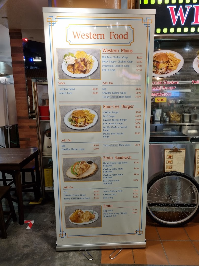 A detailed menu board displaying Western food, burgers, and prata dishes with prices.