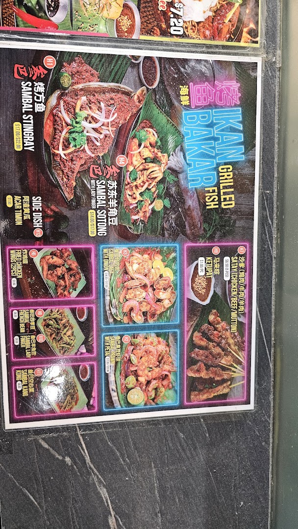 A vibrant menu displaying a variety of grilled seafood, satay, and traditional Malay side dishes.