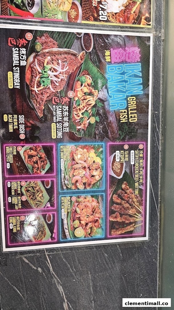 A vibrant menu displaying a variety of grilled seafood, satay, and traditional Malay side dishes.