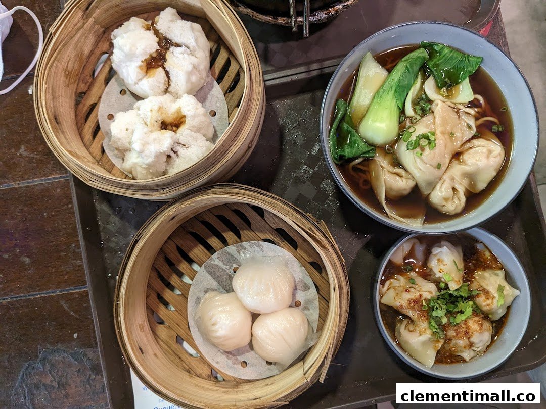 A delicious spread of dim sum, wanton noodles, and chili oil wontons served on a tray.