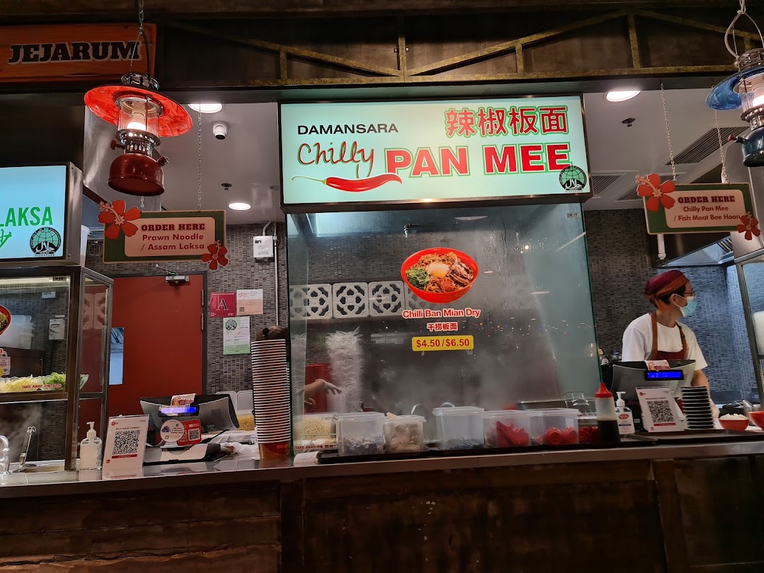 A food stall counter at Boleh Boleh! Clementi Mall, featuring 'Chilly Pan Mee' and 'Laksa' signage.