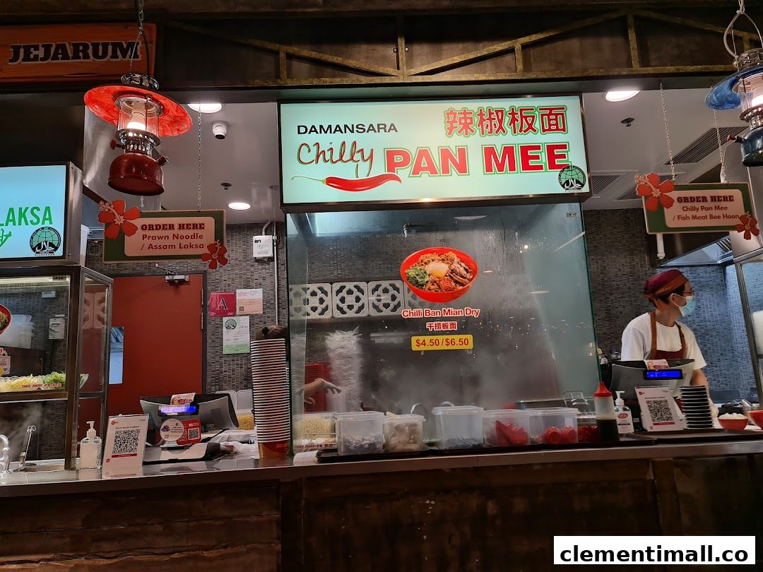 A food stall counter at Boleh Boleh! Clementi Mall, featuring 'Chilly Pan Mee' and 'Laksa' signage.