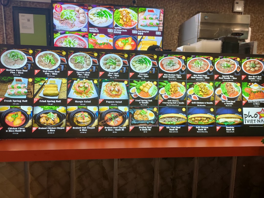A vibrant digital menu board showcasing a variety of Vietnamese dishes with appealing images and prices.