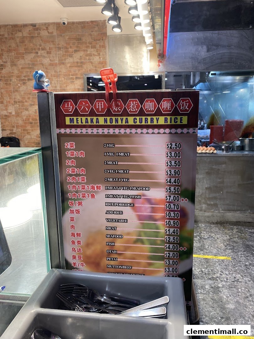 A menu board displaying prices and options for Melaka Nonya Curry Rice.